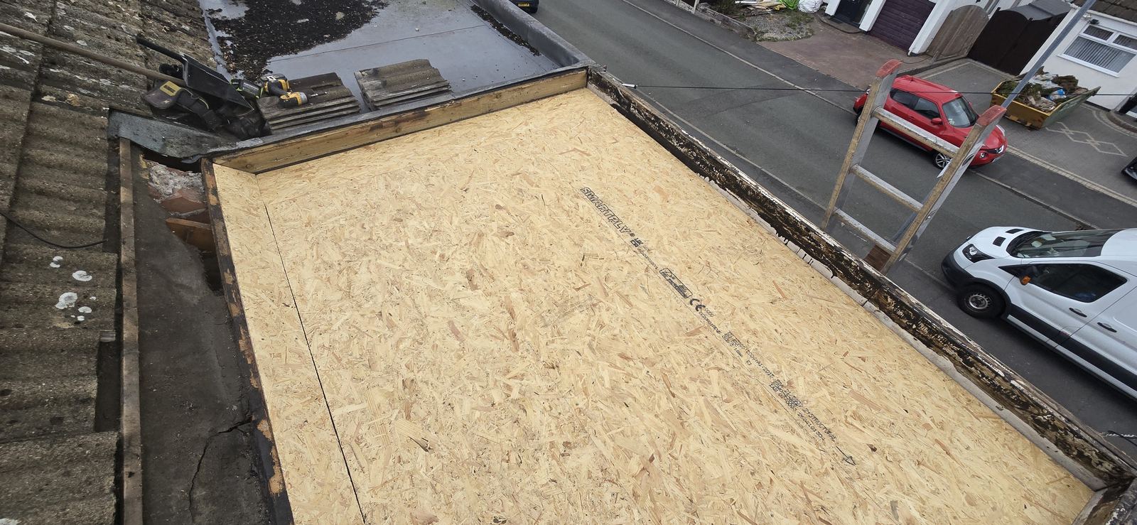 Flat roof stripped back to the timber deck before recovering