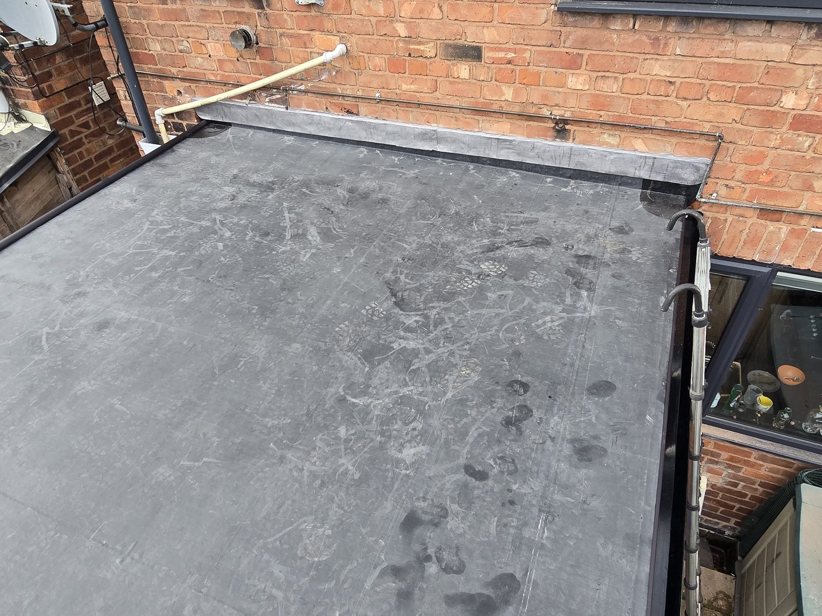 Completed EPDM rubber flat roof with new lead flashing chased into the brickwork in Connah's Quay