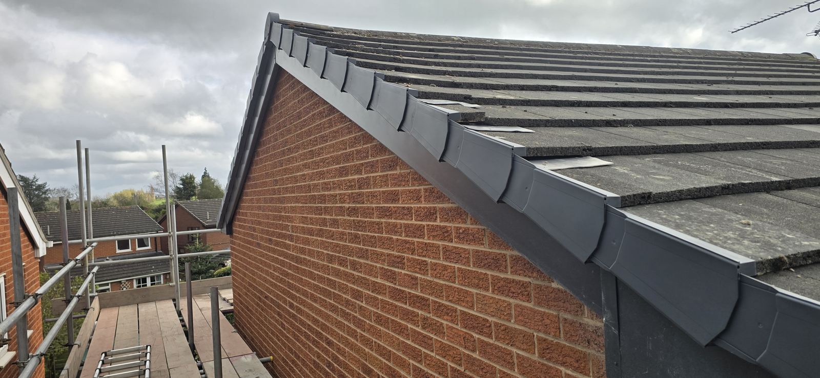 New anthracite grey UPVC fascia and guttering along a gable end