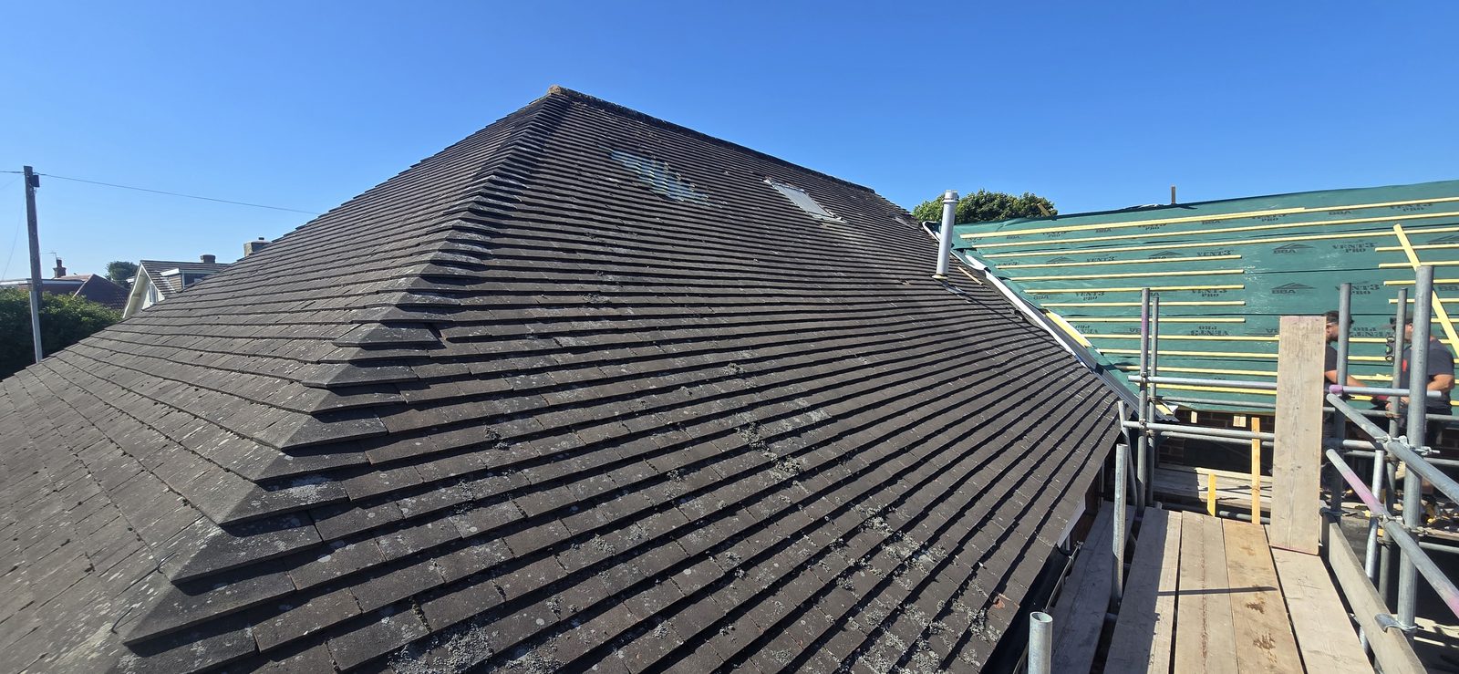 Original weathered, lichen-covered concrete tile roof on a Hawarden bungalow before re-roofing