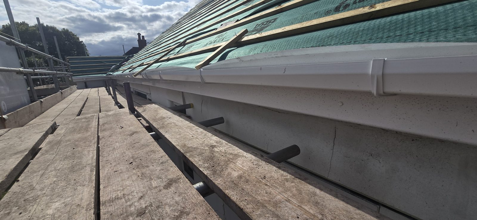 New white UPVC guttering fitted to the new fascia boards