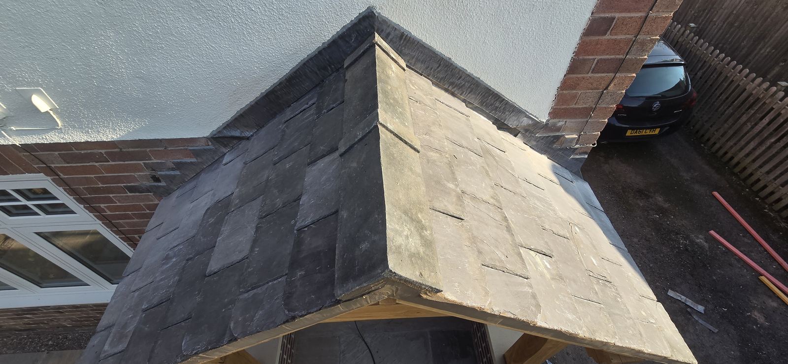 Slate roof valley with lead flashing detail on a porch canopy