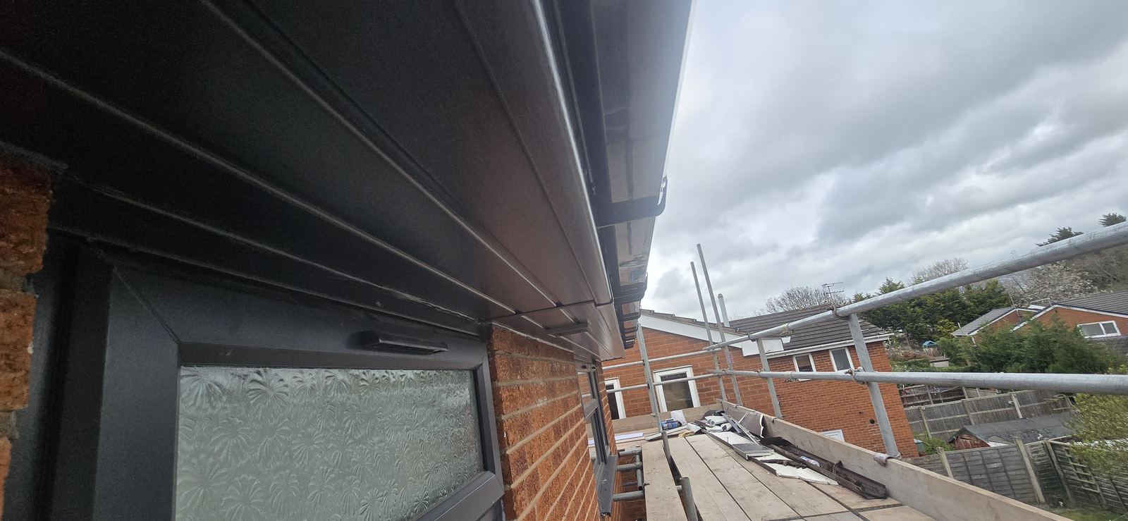 New anthracite 18mm fascia, hollow soffit and guttering fitted by LSE Roofing in Wrexham